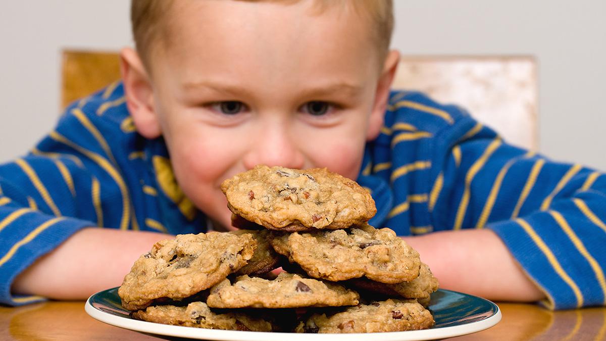 boy gazing at cookies on National Cookie Day