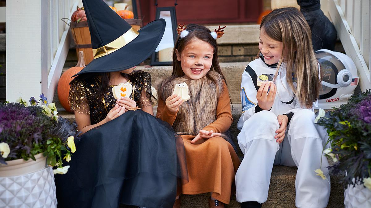 kids eating cookies at a costume party