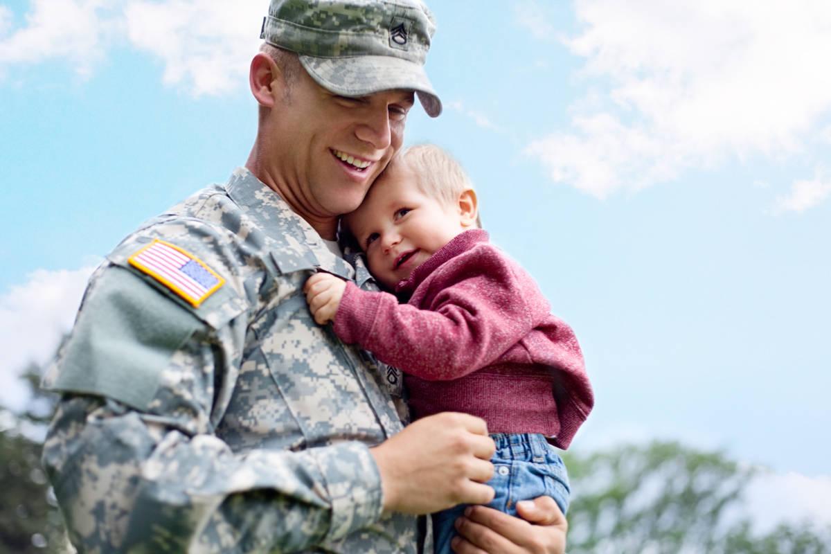 Military father holding son
