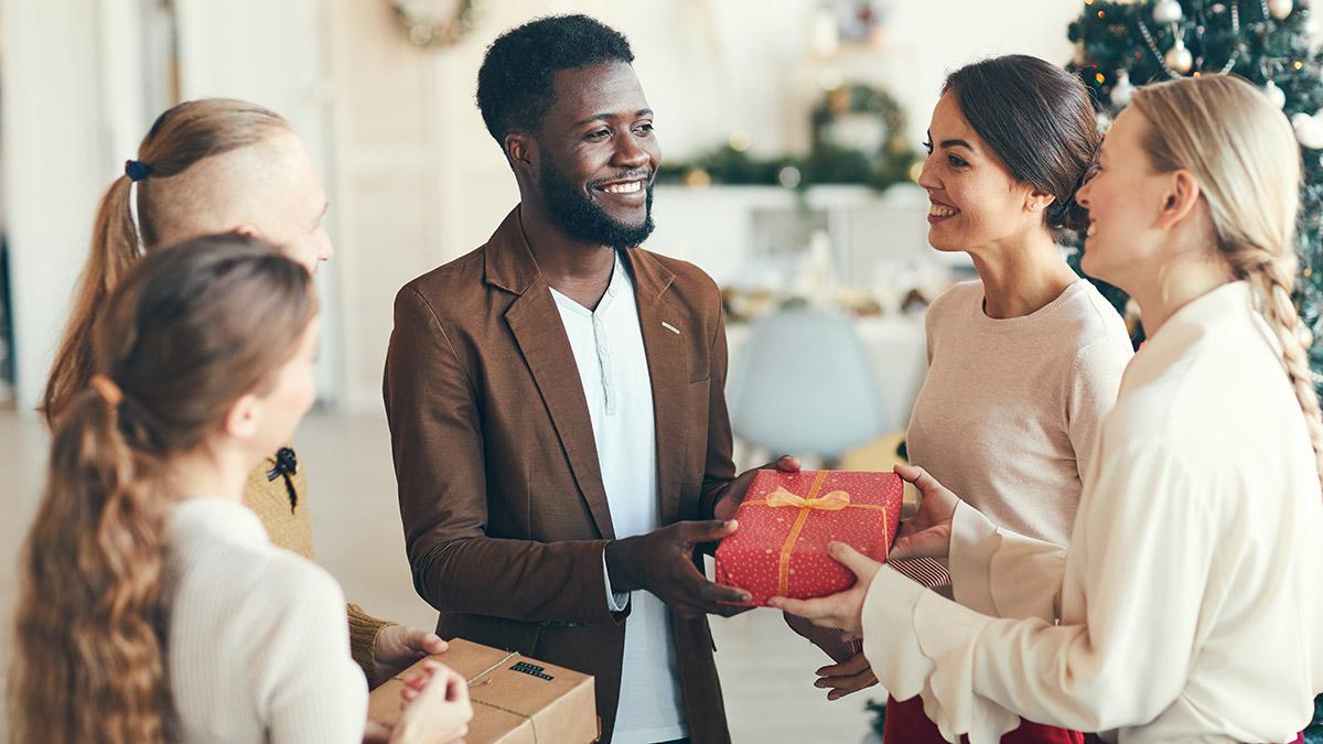 man giving gift to holiday hostess