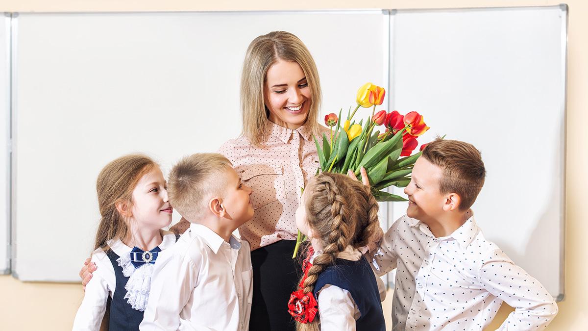 Photo of a teacher getting flowers from her students