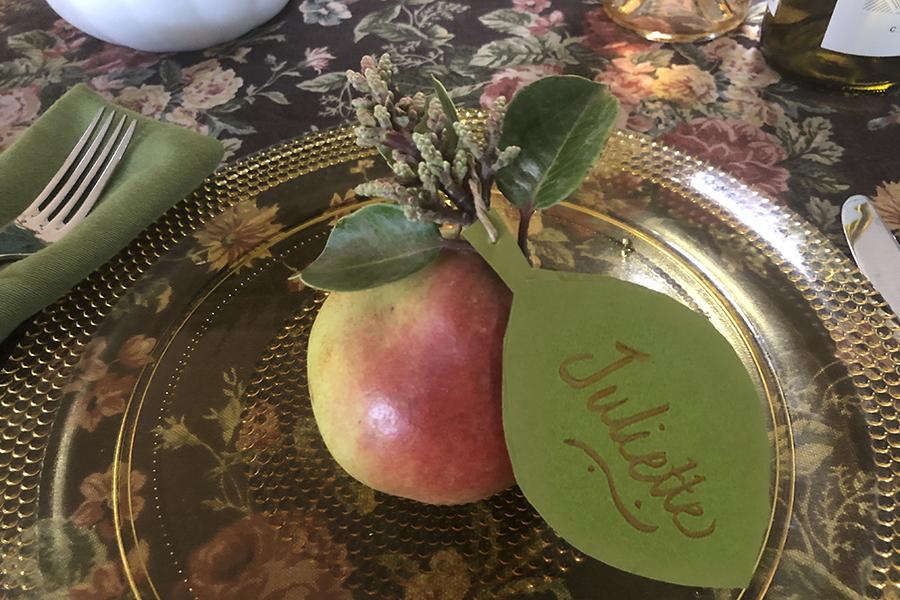 Photo of paper autumn leaf place setting with a pear