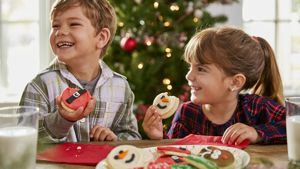 Photo of children eating christmas cookies