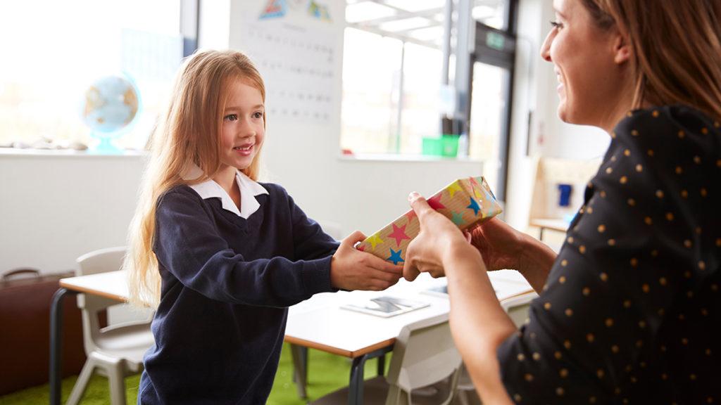 randon acts of kindness day: girl giving teacher a gift