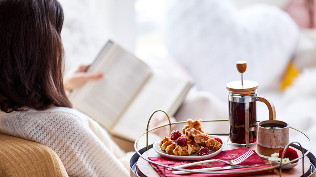 Photo of a teacher eating a relaxing breakfast