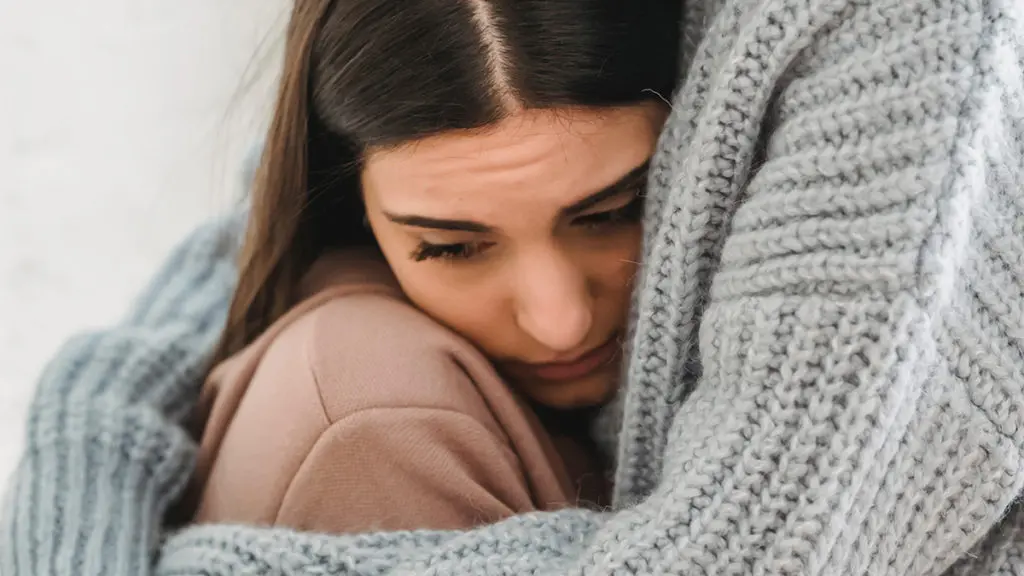 Photo of woman embraced by a friend