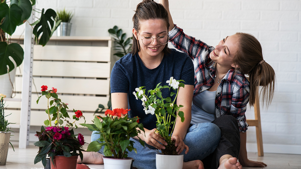 At home date night ideas with a couple planting flowers in their home.