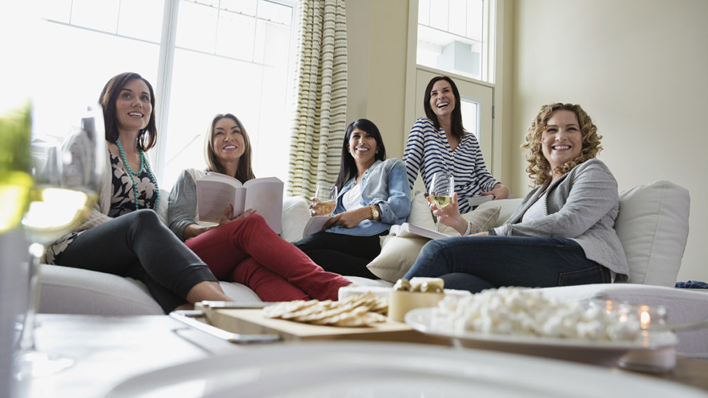 Photo of women drinking wine at a book club event