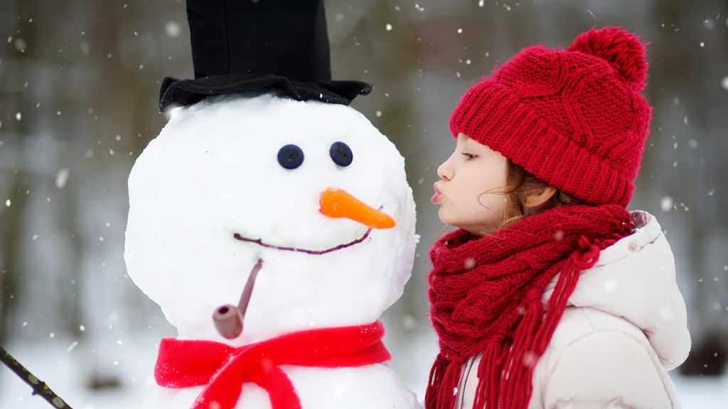 Photo of girl making a snowman