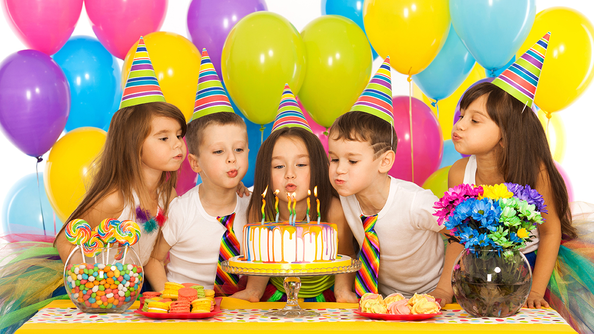 a photo of birthday traditions: kids blowing out candles