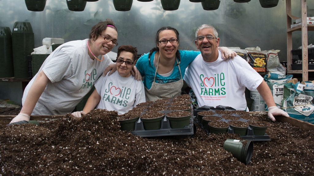 a photo of smile farms: farmers posing for picture