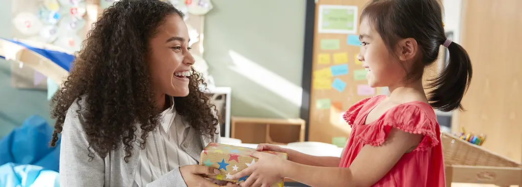 Girl giving teacher a gift