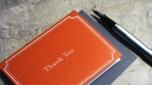 Thank You Etiquette: photo of a thank you card with a pen