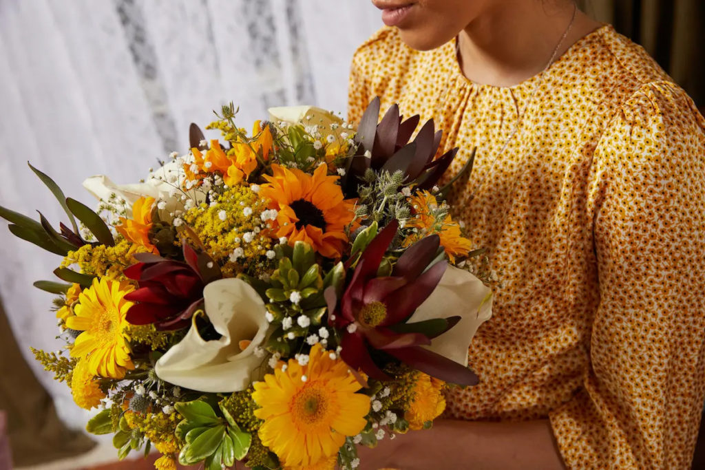 photo of milestone birthdays with girl holding flowers for th birthday